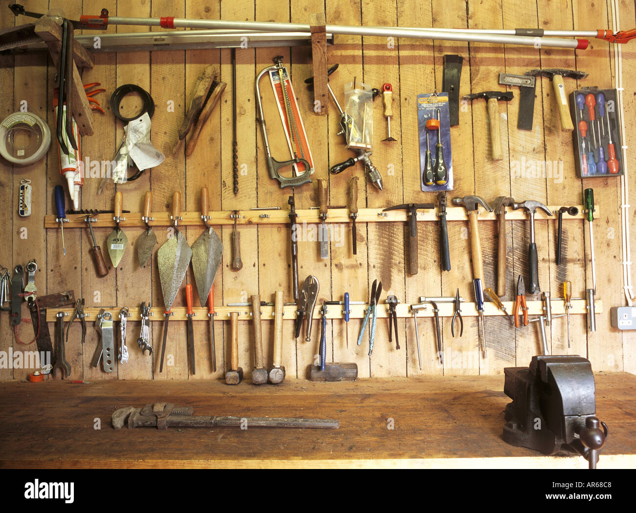 an-orderly-array-of-tools-in-the-gardener-s-tool-shed-at-hinton-ampner-AR68C8.jpg