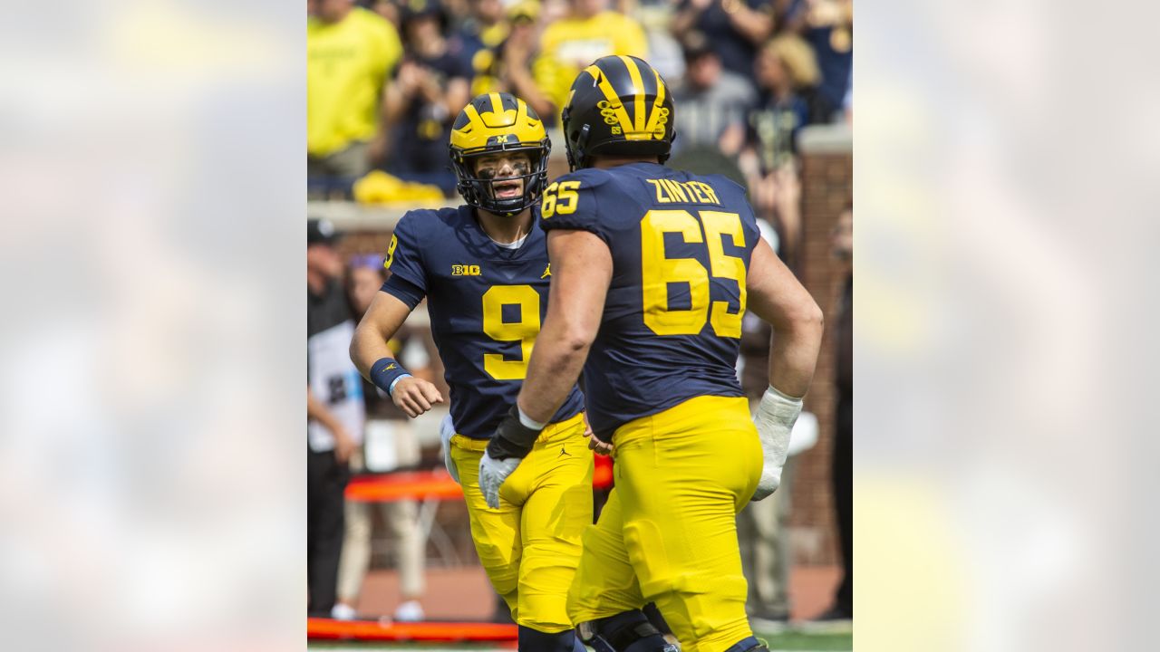 Michigan quarterback J.J. McCarthy (9) celebrates his 69-yard touchdown pass with offensive lineman Zak Zinter (65) in the fourth quarter of an NCAA college football game against Western Michigan in Ann Arbor, Mich., Saturday, Sept. 4, 2021. Michigan won 47-14. (AP Photo/Tony Ding)