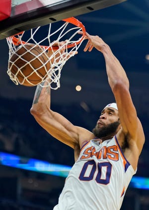 Phoenix Suns' JaVale McGee dunks against the Cleveland Cavaliers during the first half of an NBA basketball game, Wednesday, Nov. 24, 2021, in Cleveland. (AP Photo/Tony Dejak)